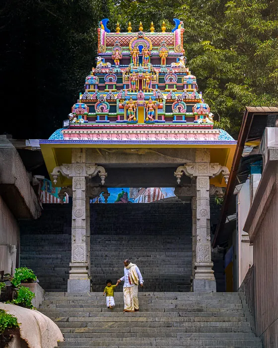A photo of a toddler and an elderly person guiding him through the steps.